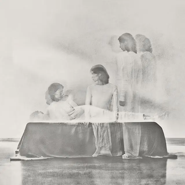 Abstract black and white photography of a figure rising from sleep.