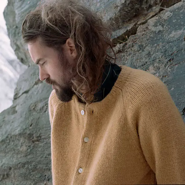 Photograph of French Perfumer, Barnabé Fillion, outdoors against a sedimentary natural landscape.  
