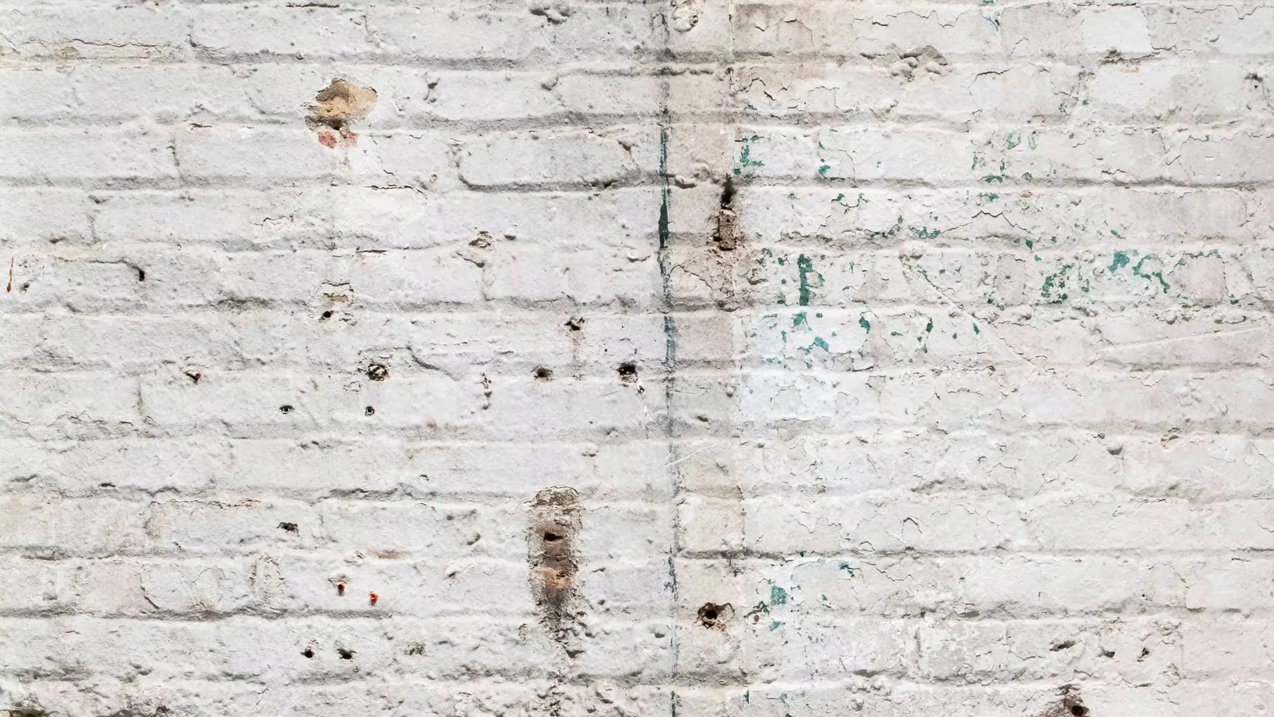 A photograph of a dry brick wall representing dry skin. 